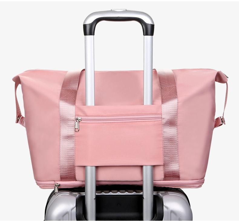 Pink gym tote on a suitcase handle